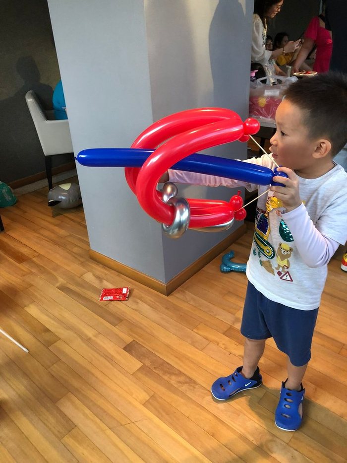 Boy playing with a balloon sword and shield