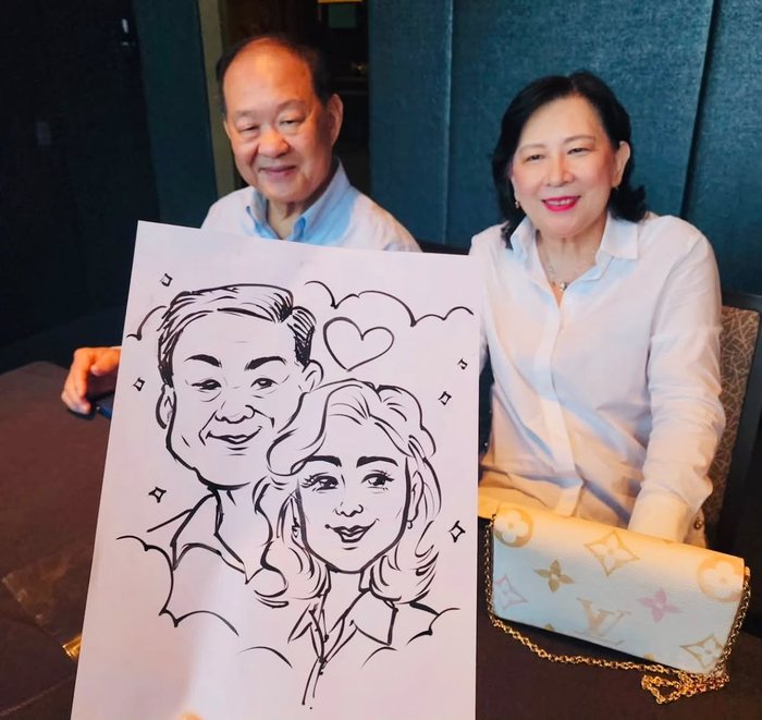 Guests holding their finished caricature