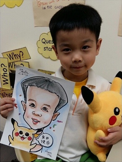Boy with his caricature and a soft toy