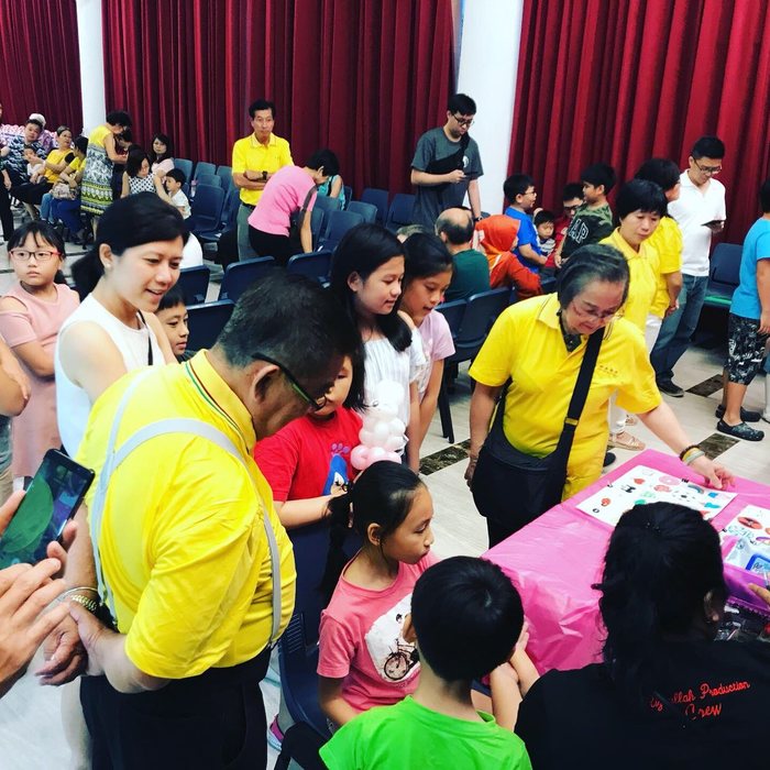 Children queuing at a party station with our artists
