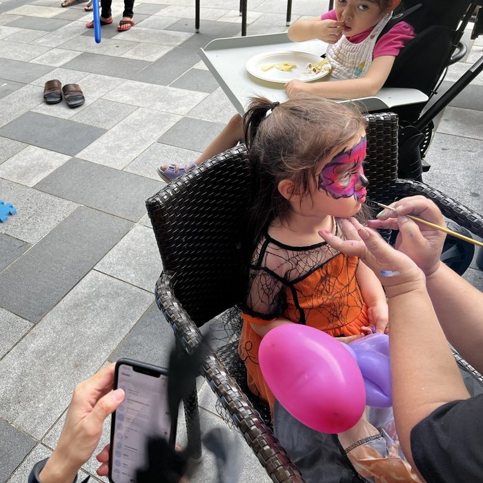 Artist painting a butterfly on a girl's face