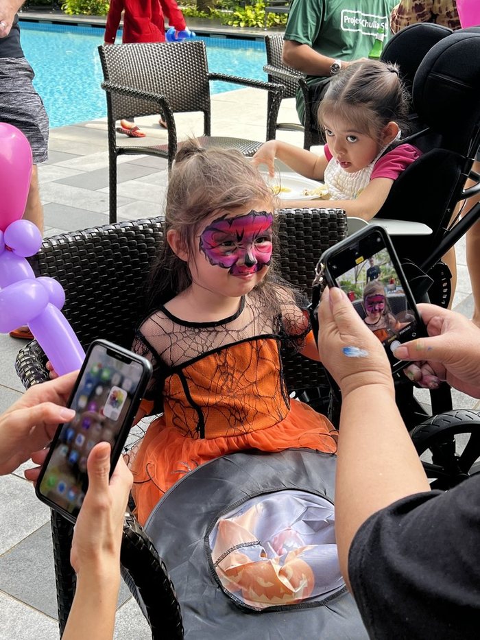 Girl showing off her finished butterfly face paint