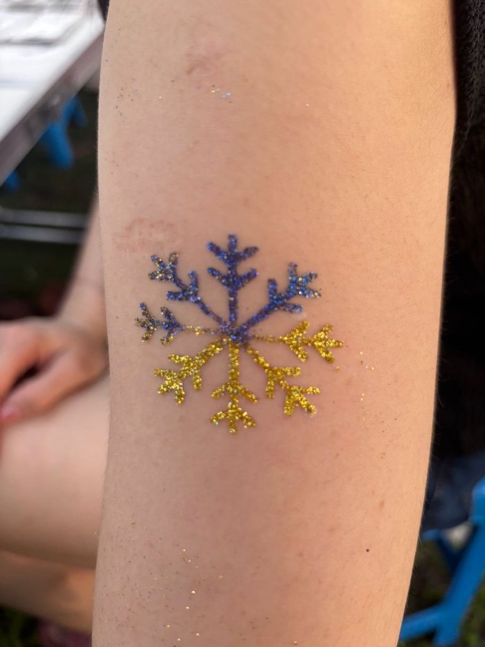 Glitter tattoo snowflake on a child's arm