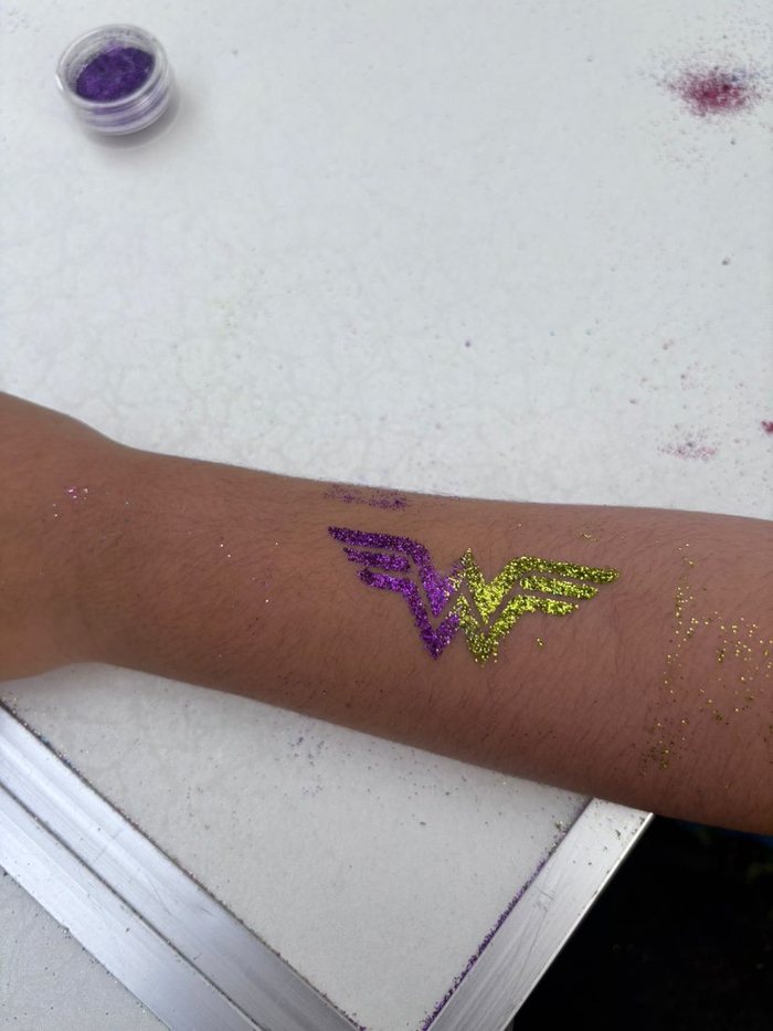 Glitter tattoo design on a child's arm