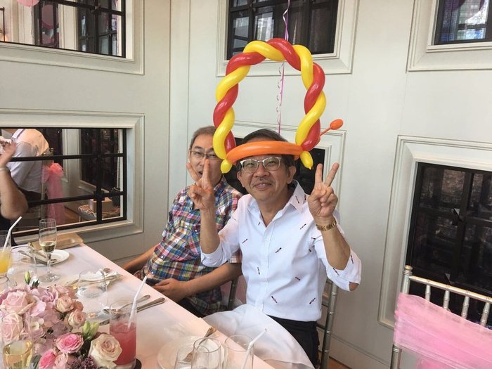 Guest laughing in a balloon crown